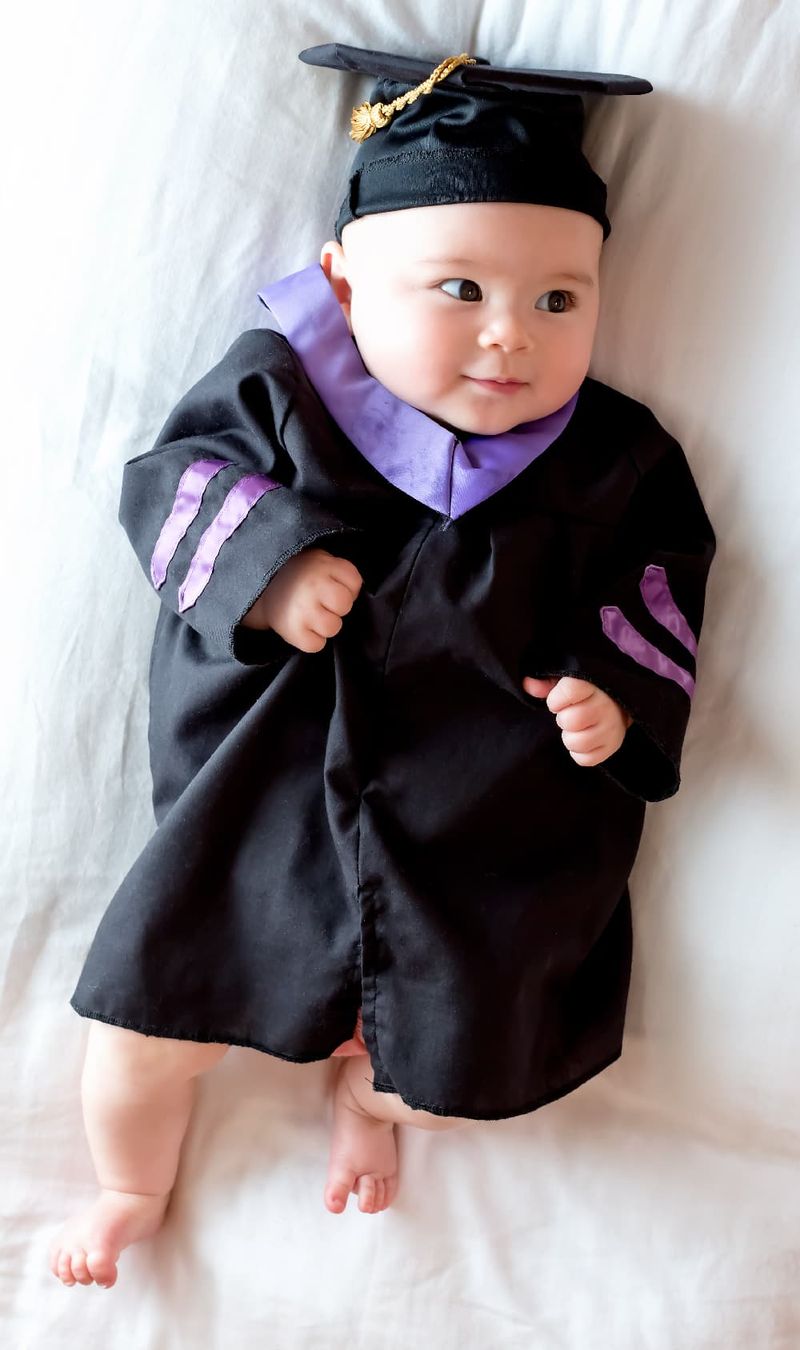 A baby with a graduation gown and cap